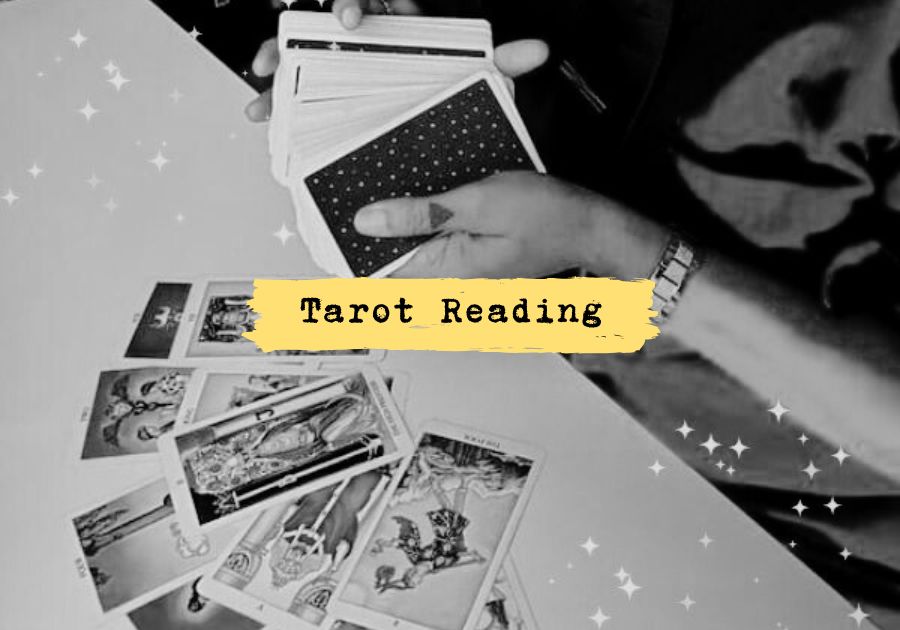 Black and white photo of King Gaia holding tarot cards during an intuitive reading session — sacred tarot guidance for clarity, direction, and shadow work alignment.